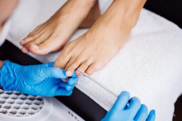 pedicure-process-home-salon-pedicure-foot-care-treatment-nail-process-professional-pedicures-master-blue-gloves-make-pedicure