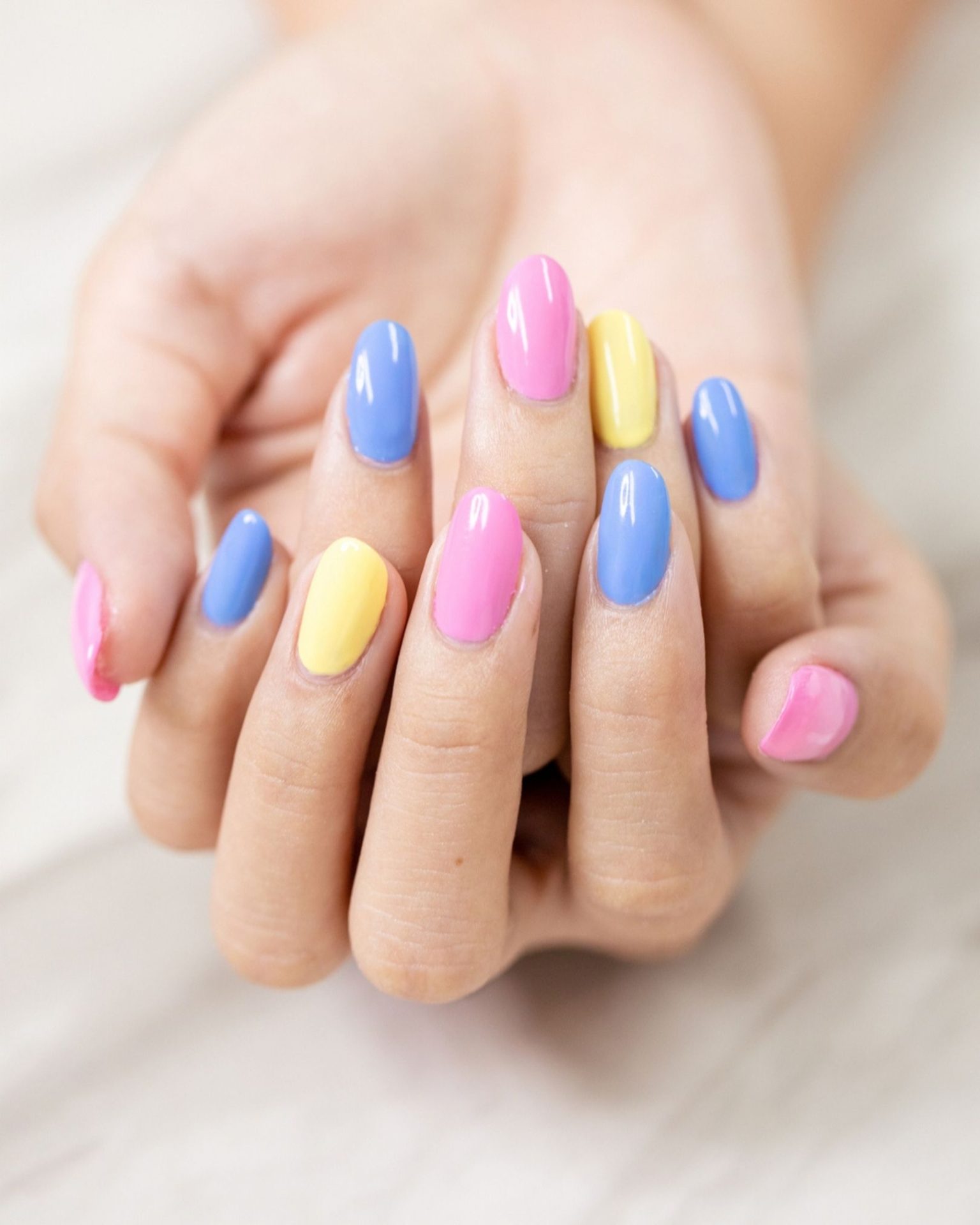Almond-shaped nails in bright pastel gradient