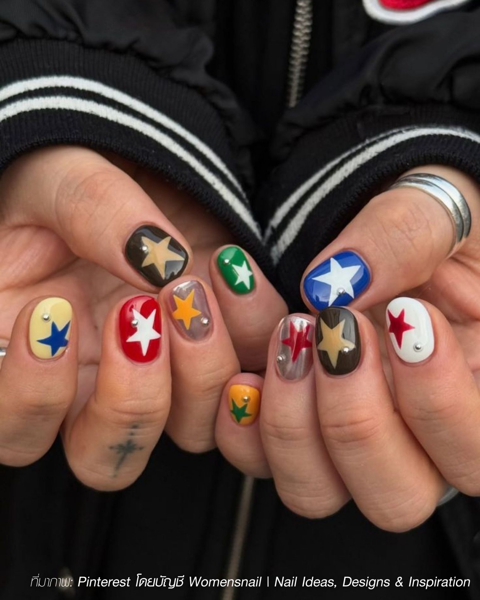 Fashionable men's nails with multi-colored painted stars and silver studs
