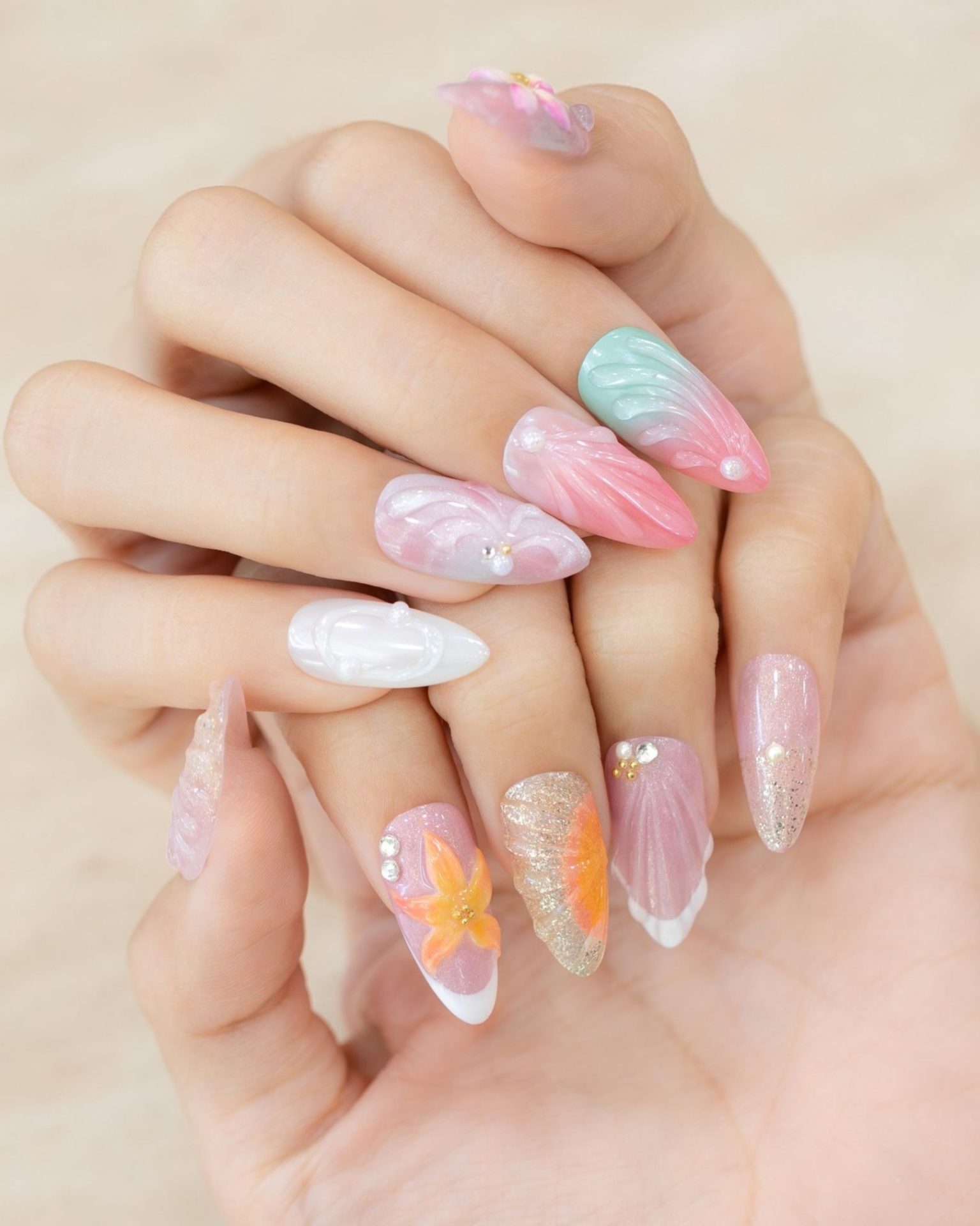 Mixed nail design with sea, seashells, and flowers