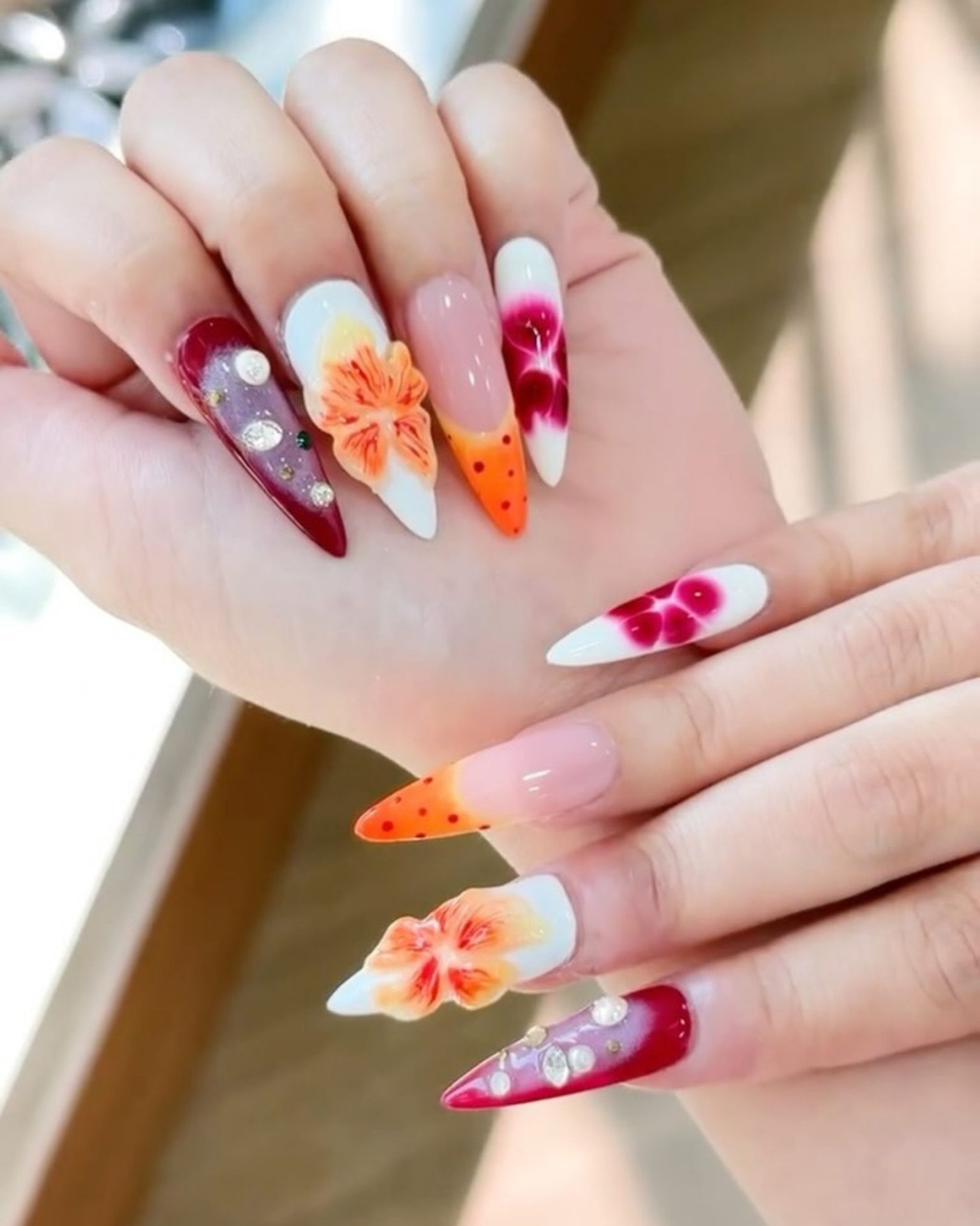 Bright red nail art decorated with 3D raised flowers