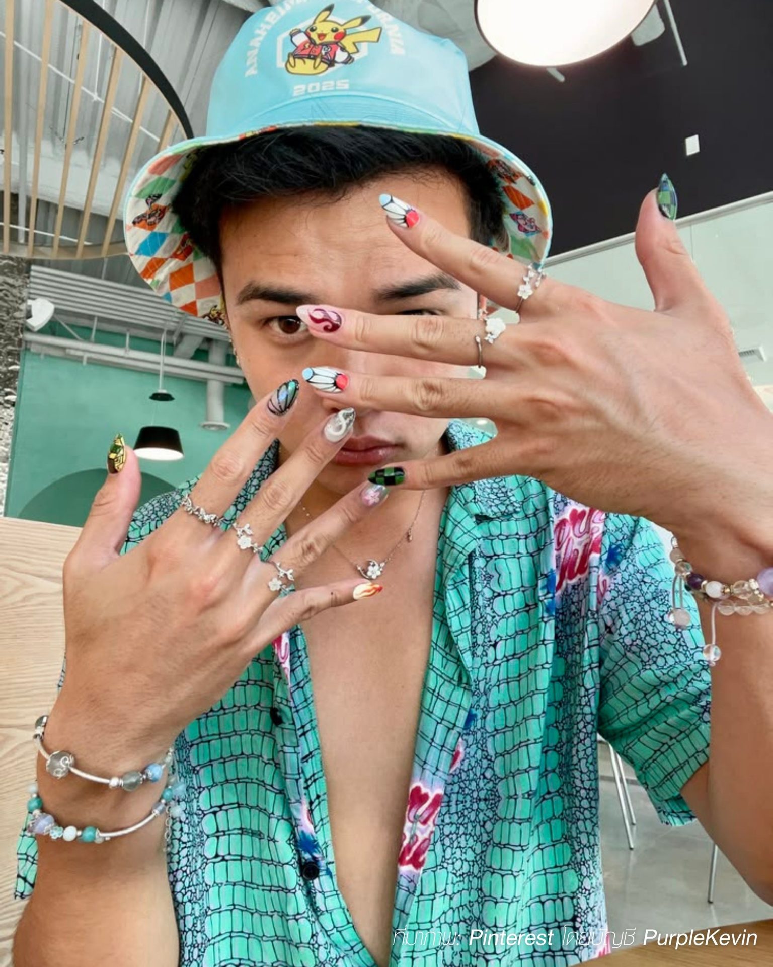 Colorful graphic nail art with butterfly motifs for fashion-forward men