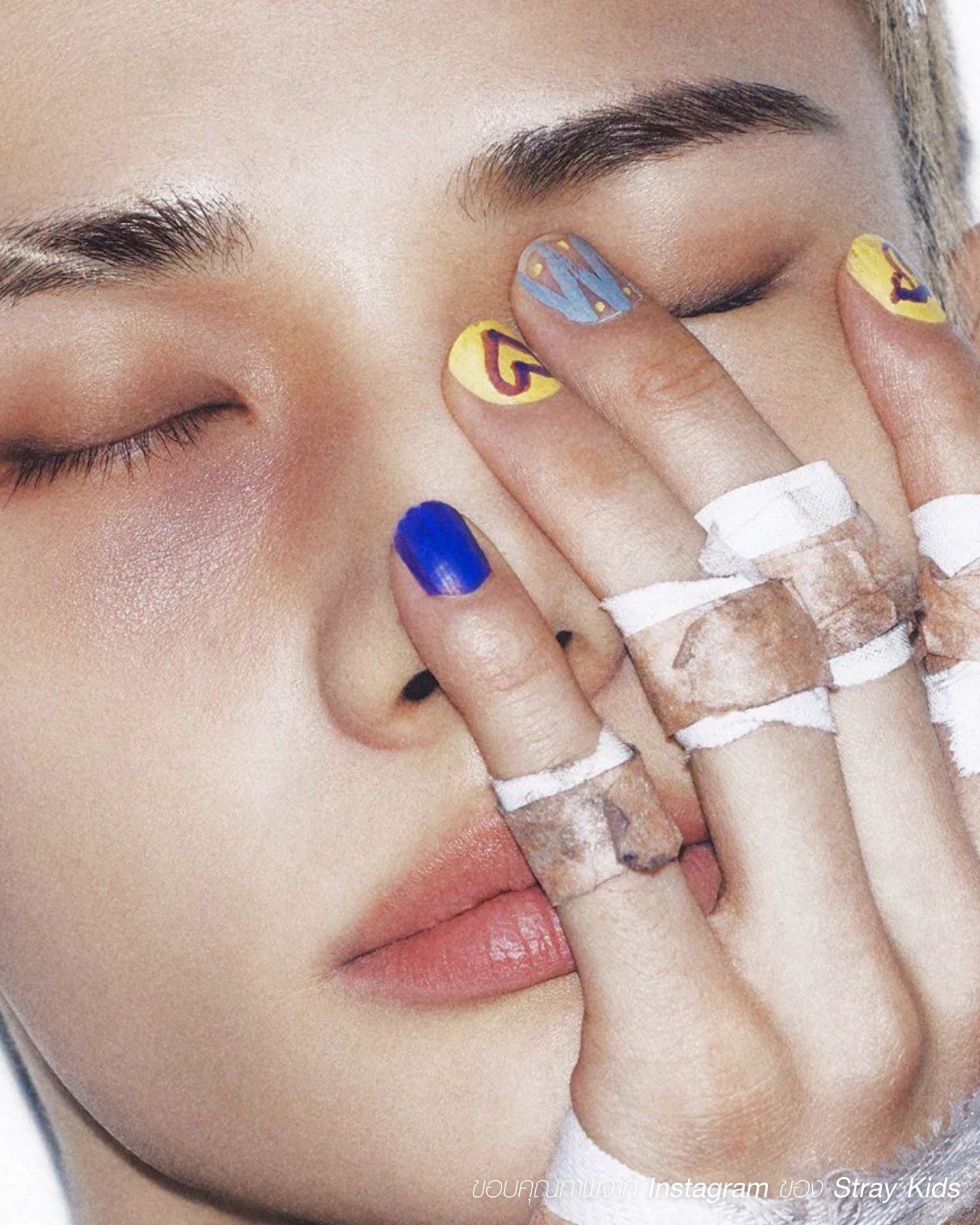 Bright colored men's nail trend with hearts and icon-style bandage accents