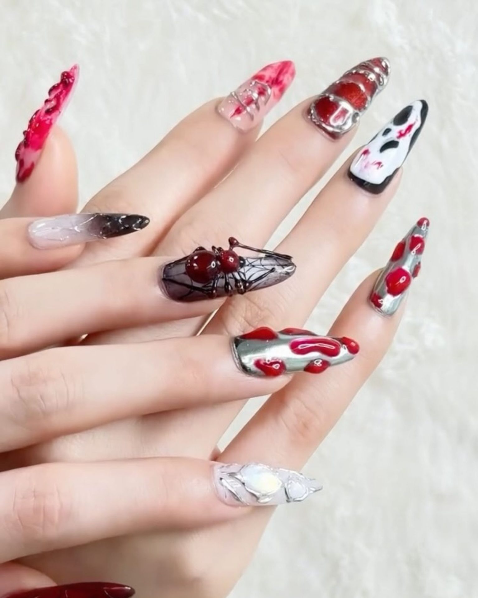 Spooky design nails decorated with 3D blood and spider accents