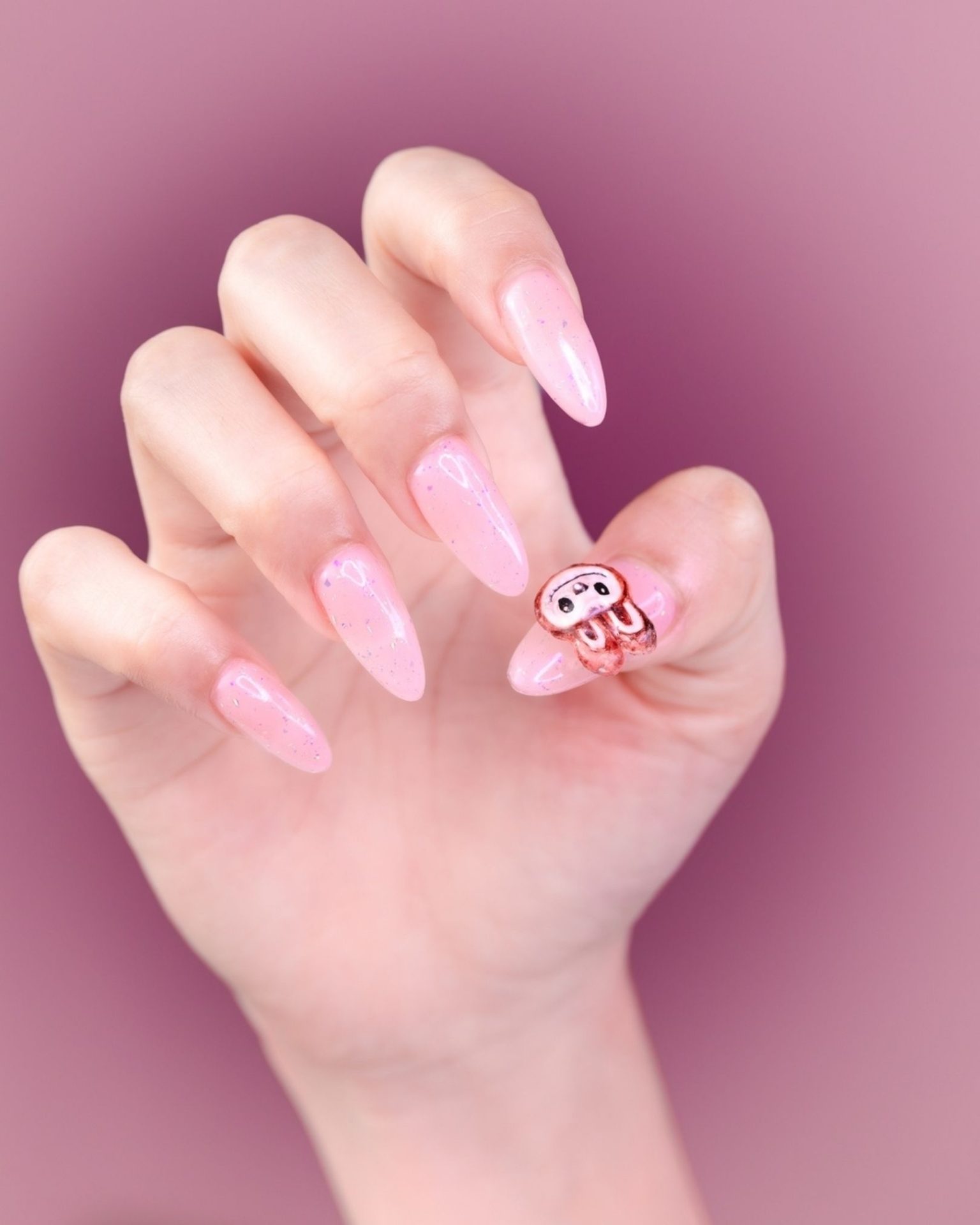 Long almond nails in pink tone painted with adorable bunny design