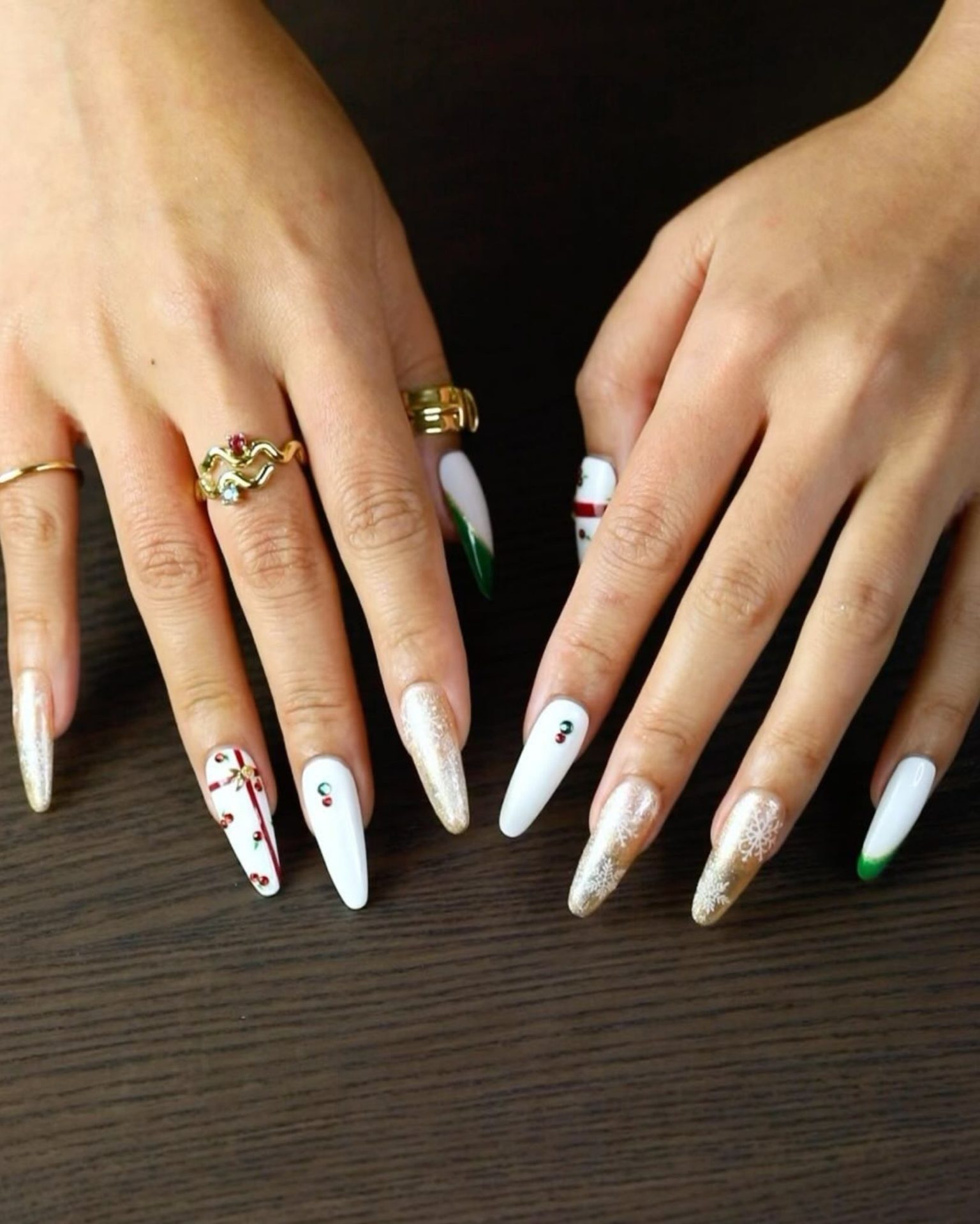 White and gold Christmas theme nail art with snowflake design