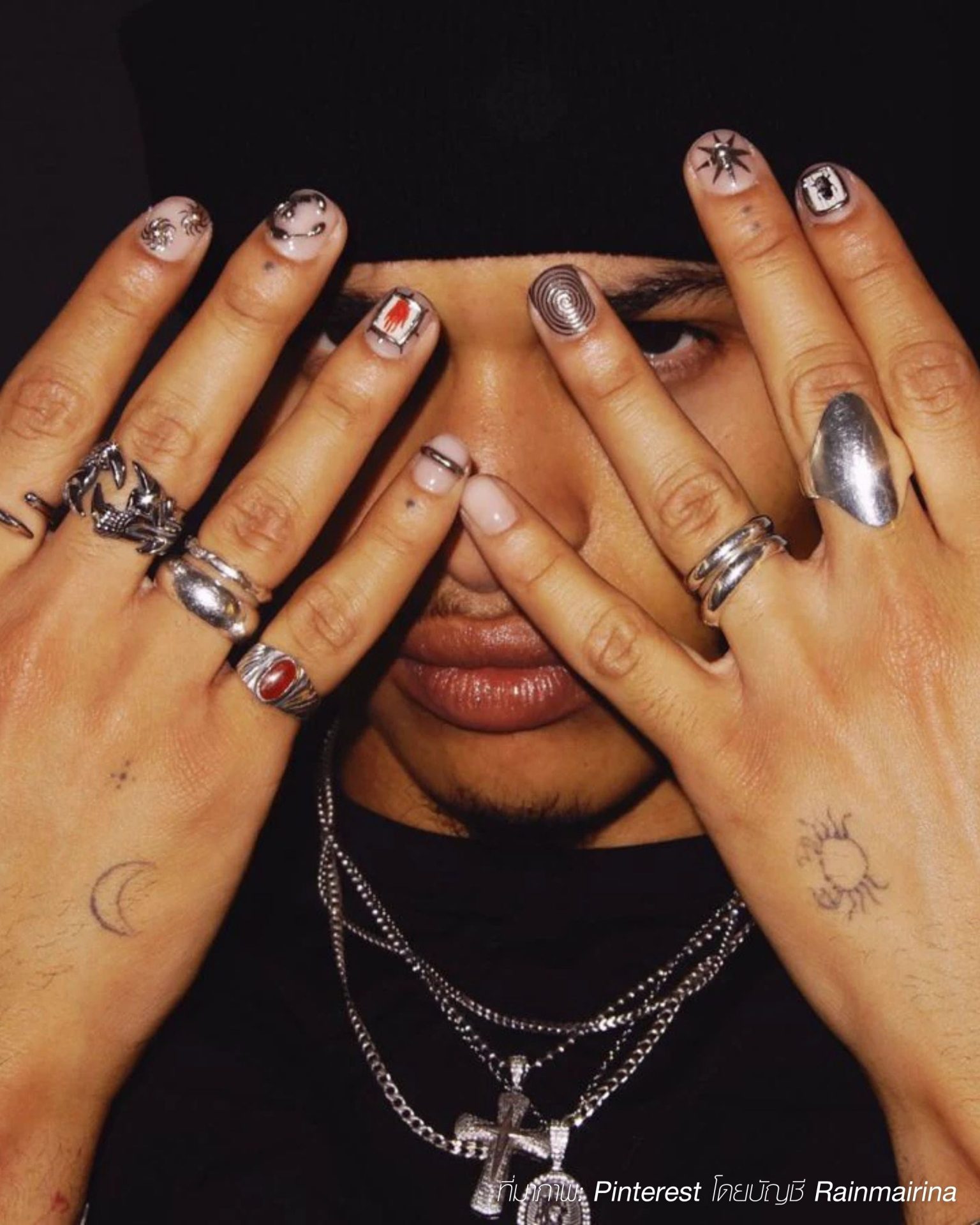 Artistic men's minimal nails with unique graphics paired with silver rings