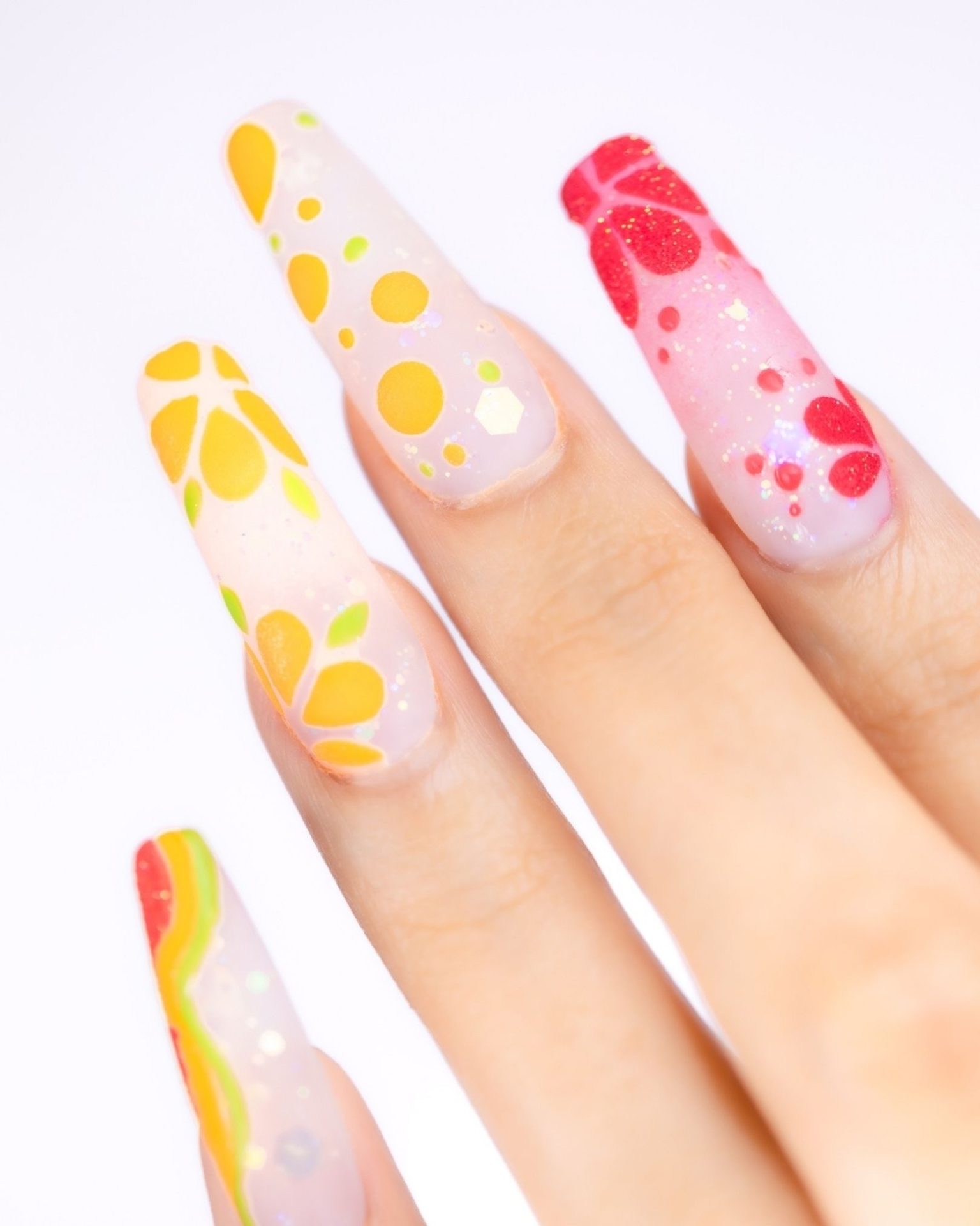 Fruit-themed nail art in orange and yellow tones, bright for summer
