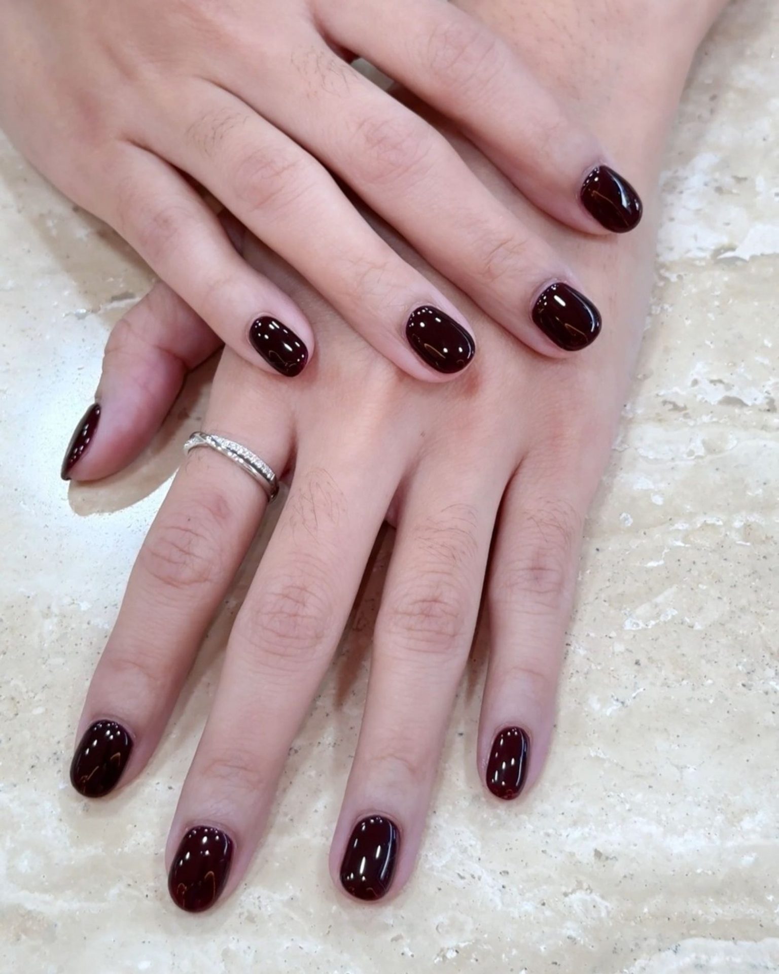 Short round nails in Burgundy red, classic glossy finish, elegant luxe look