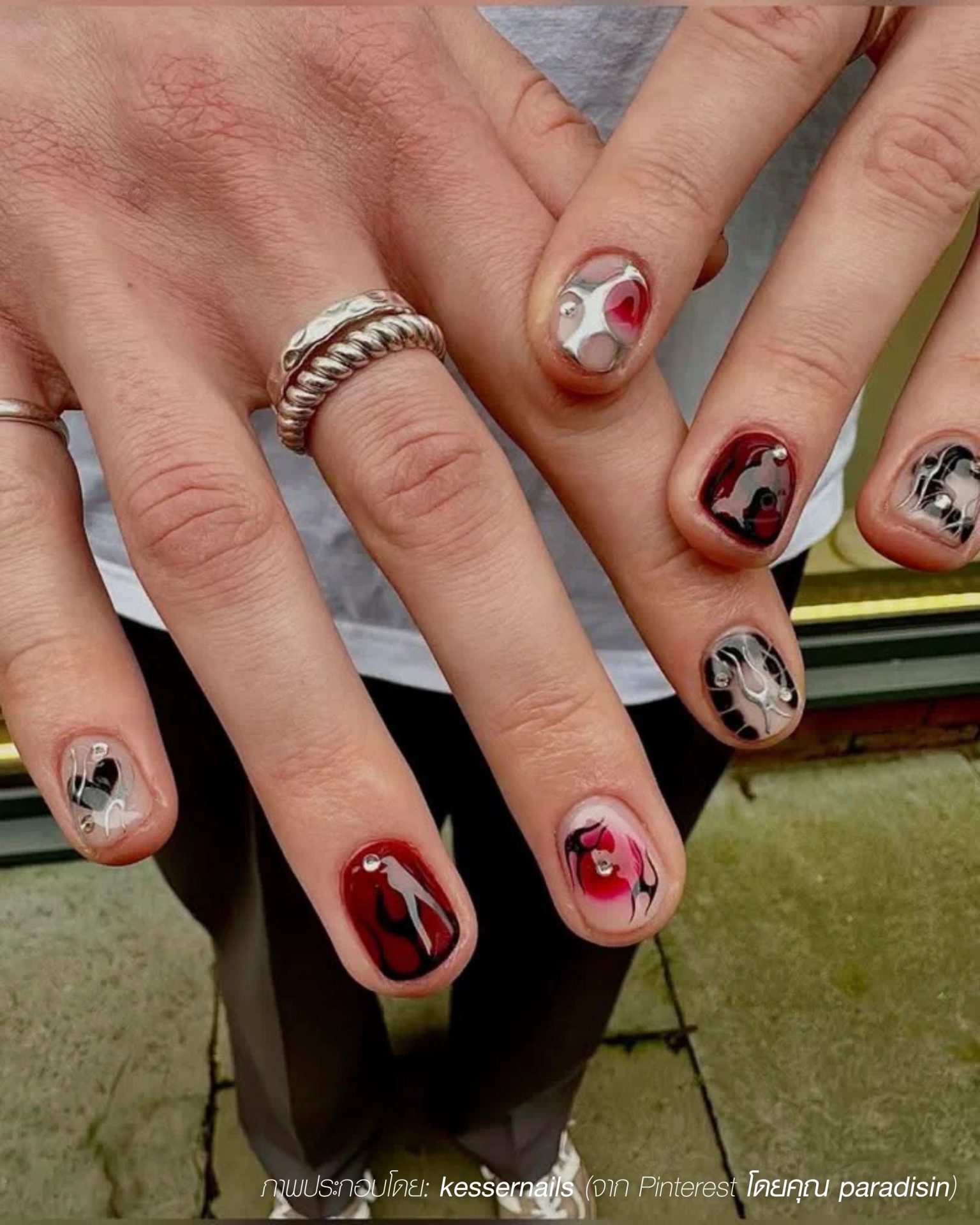 Advanced fashion look with men's nail painting ideas featuring hearts and silver art