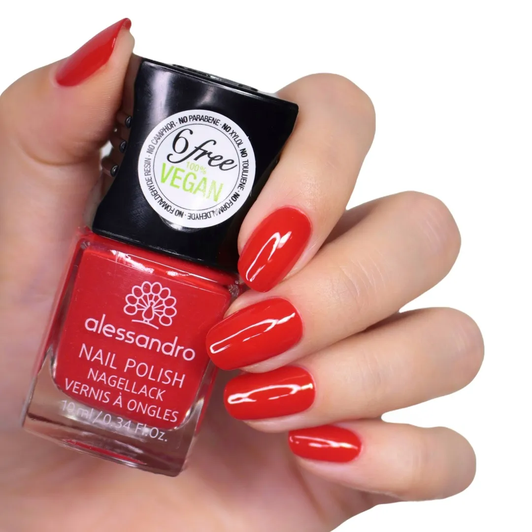 Hand with polished nails holding an Alessandro Nail Polish 5 ml bottle